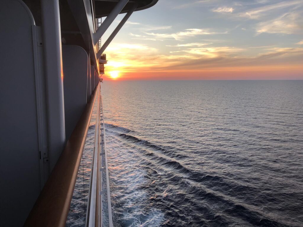 Cruise ship sails at sunset