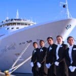 workers in front of a cruise ship