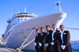 workers in front of a cruise ship