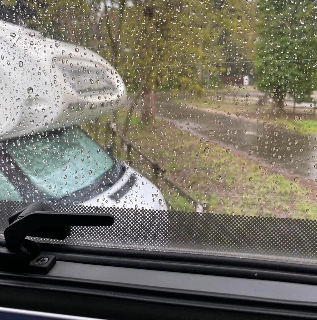 Rainy campsite view through a window